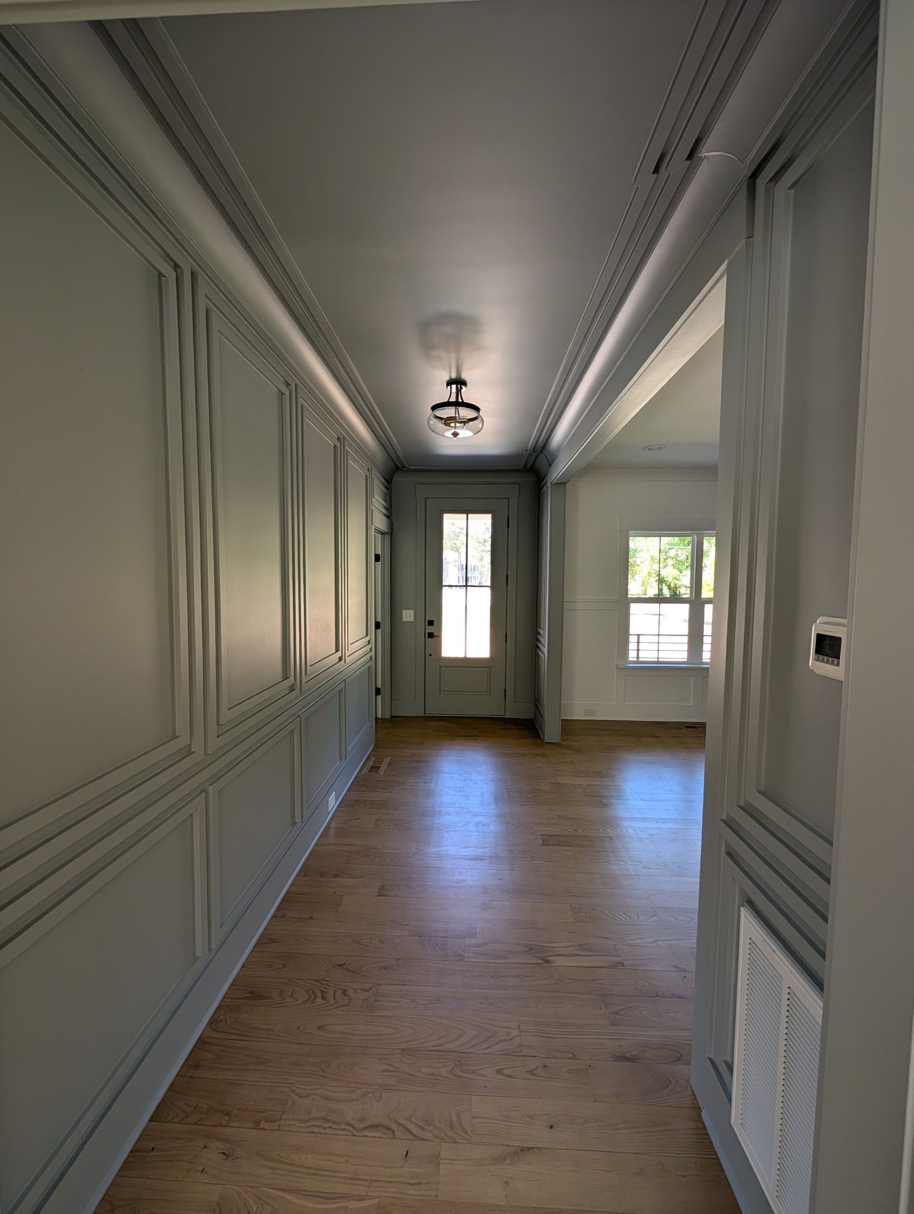 Interior Painting — hallway with sage-green wainscoting in Cary, NC