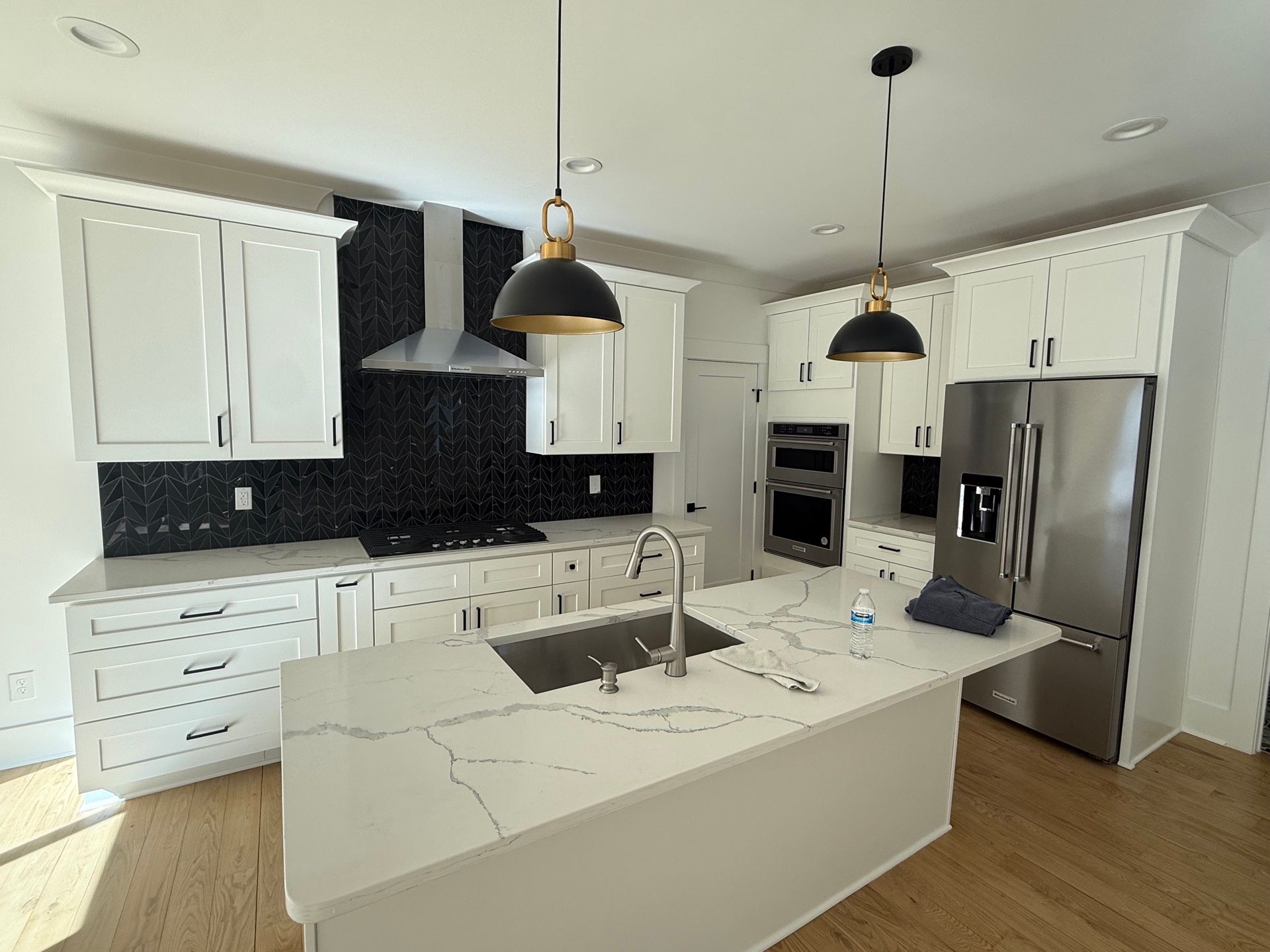 Cabinet Painting — finished kitchen with white shaker cabinets and quartz island in Durham, NC
