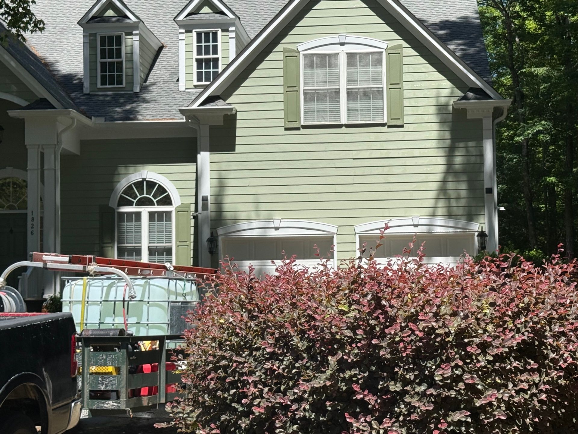 Exterior Painting — sage green two-story home with white trim and olive shutters in Hillsborough, NC