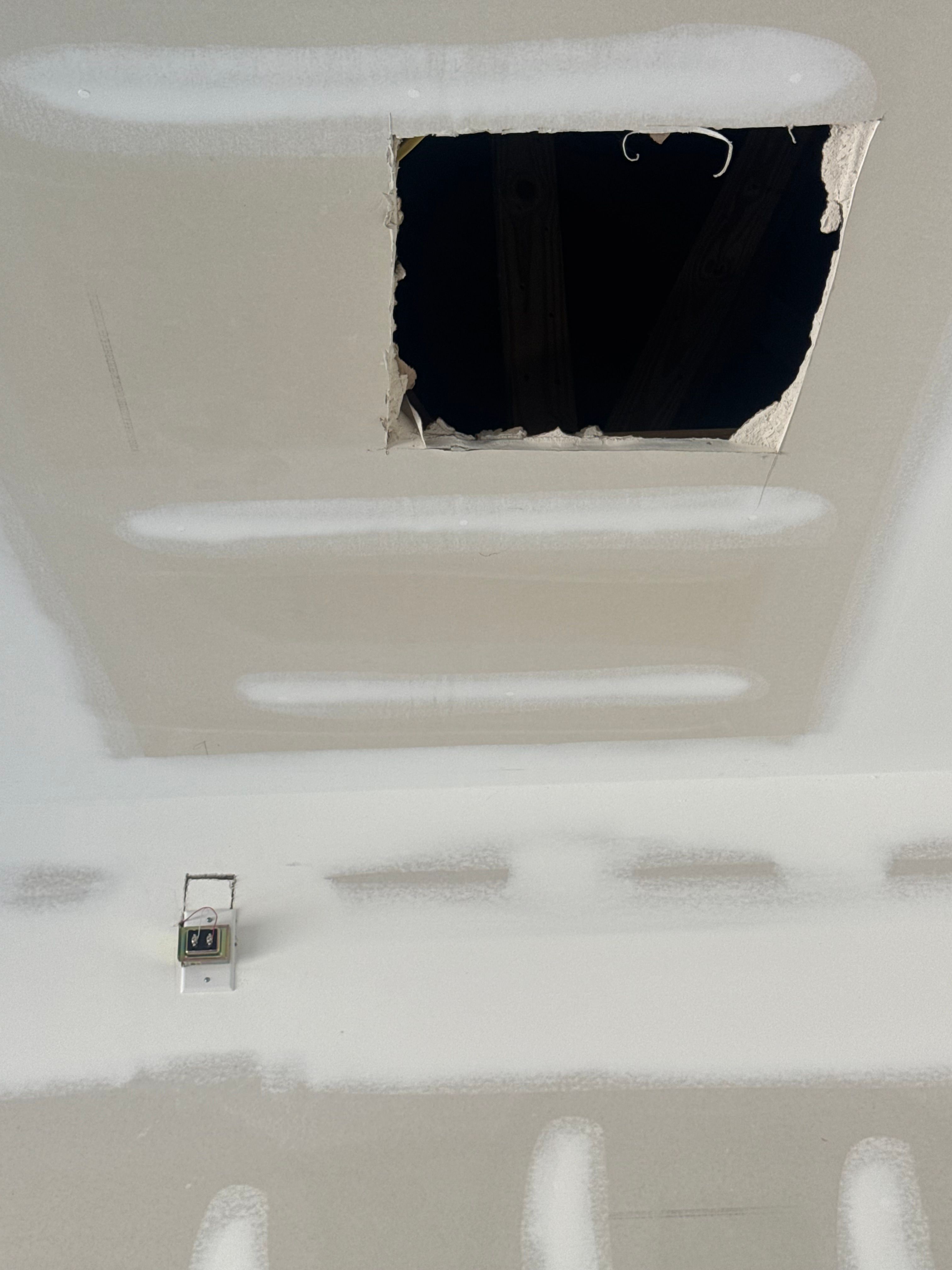 Drywall Repair — wall with square access cutout and fresh joint compound alongside in Durham, NC