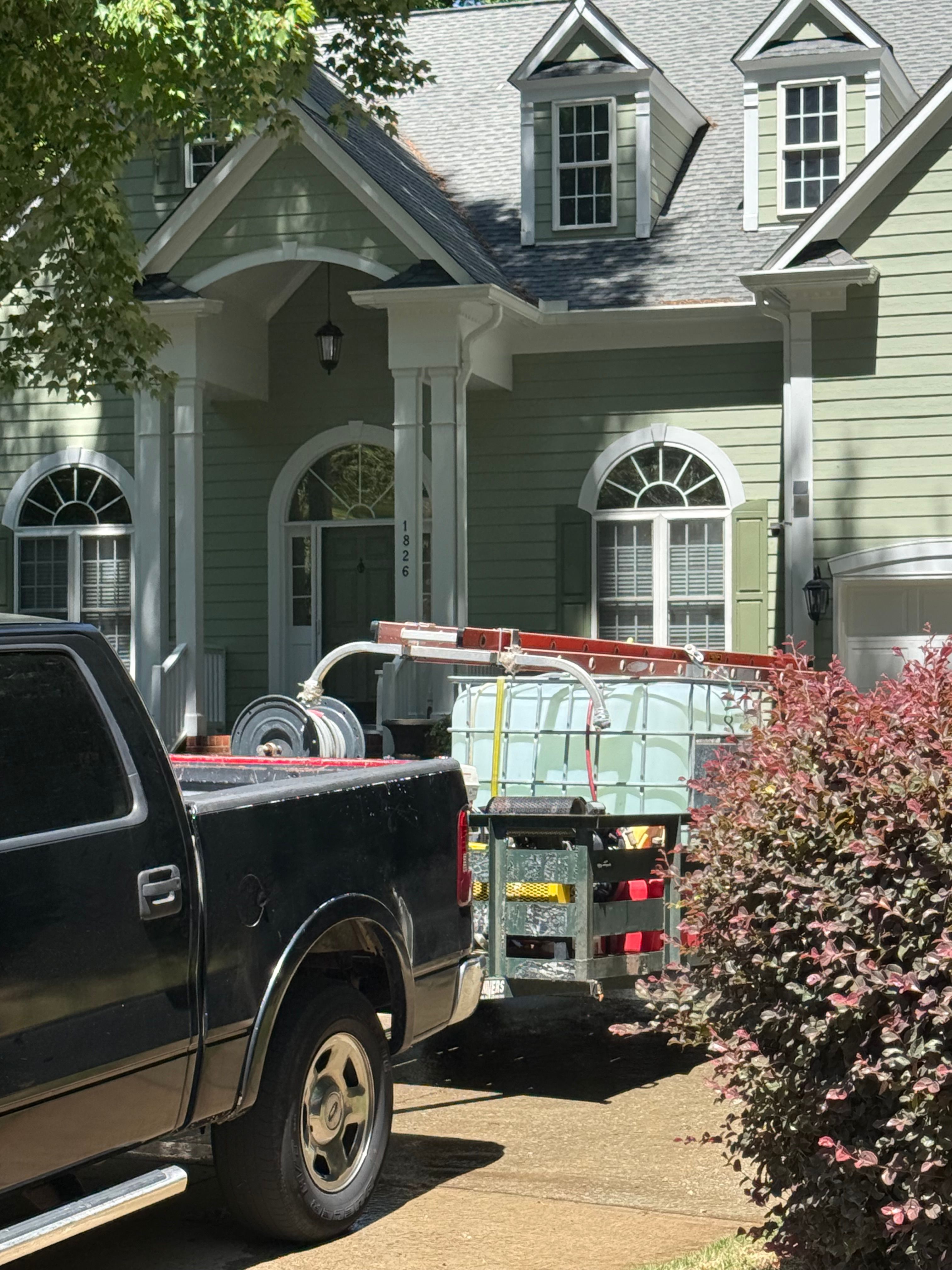 Pressure Washing — craftsman-style home with pressure washing equipment staged at the driveway in Hillsborough, NC