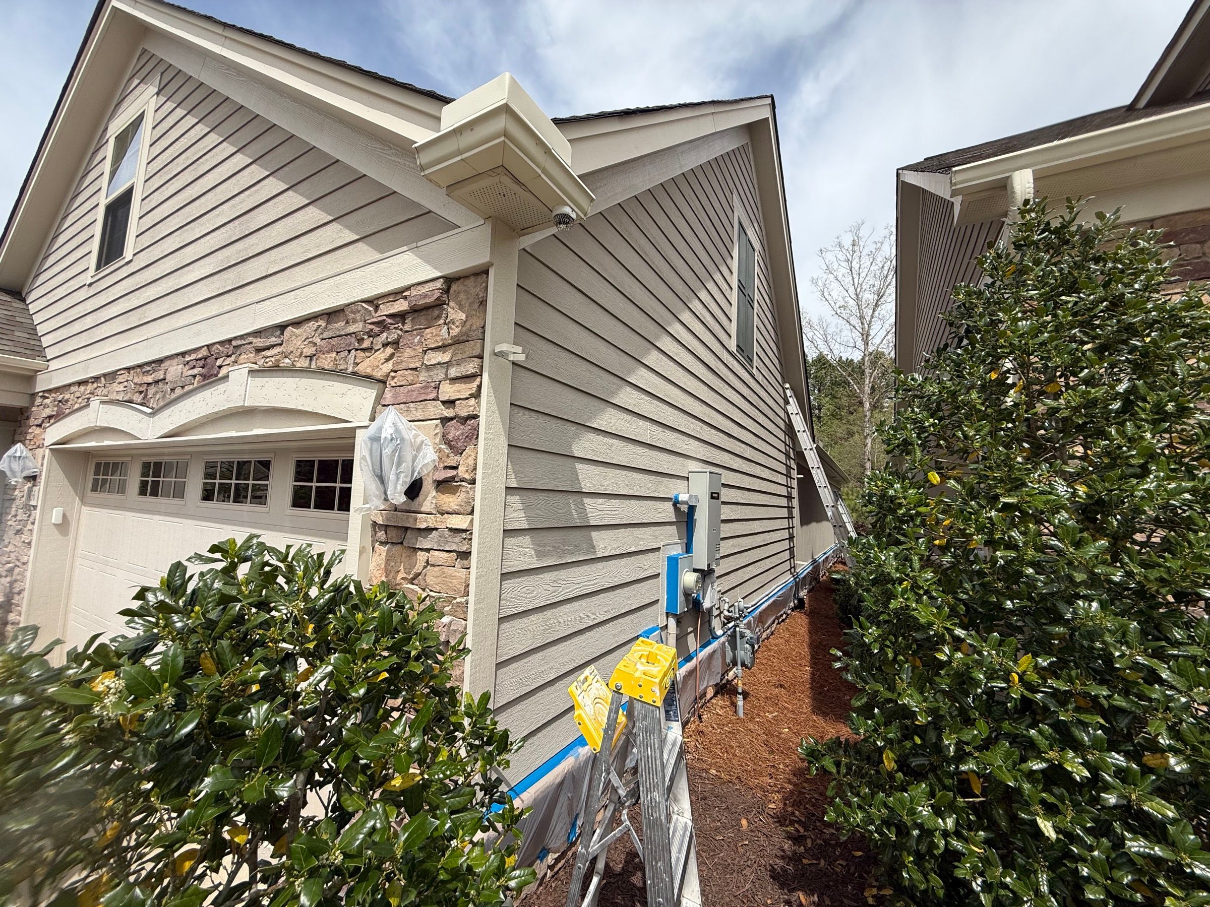 Exterior Painting — gray lap siding and white trim freshly coated in Cary, NC
