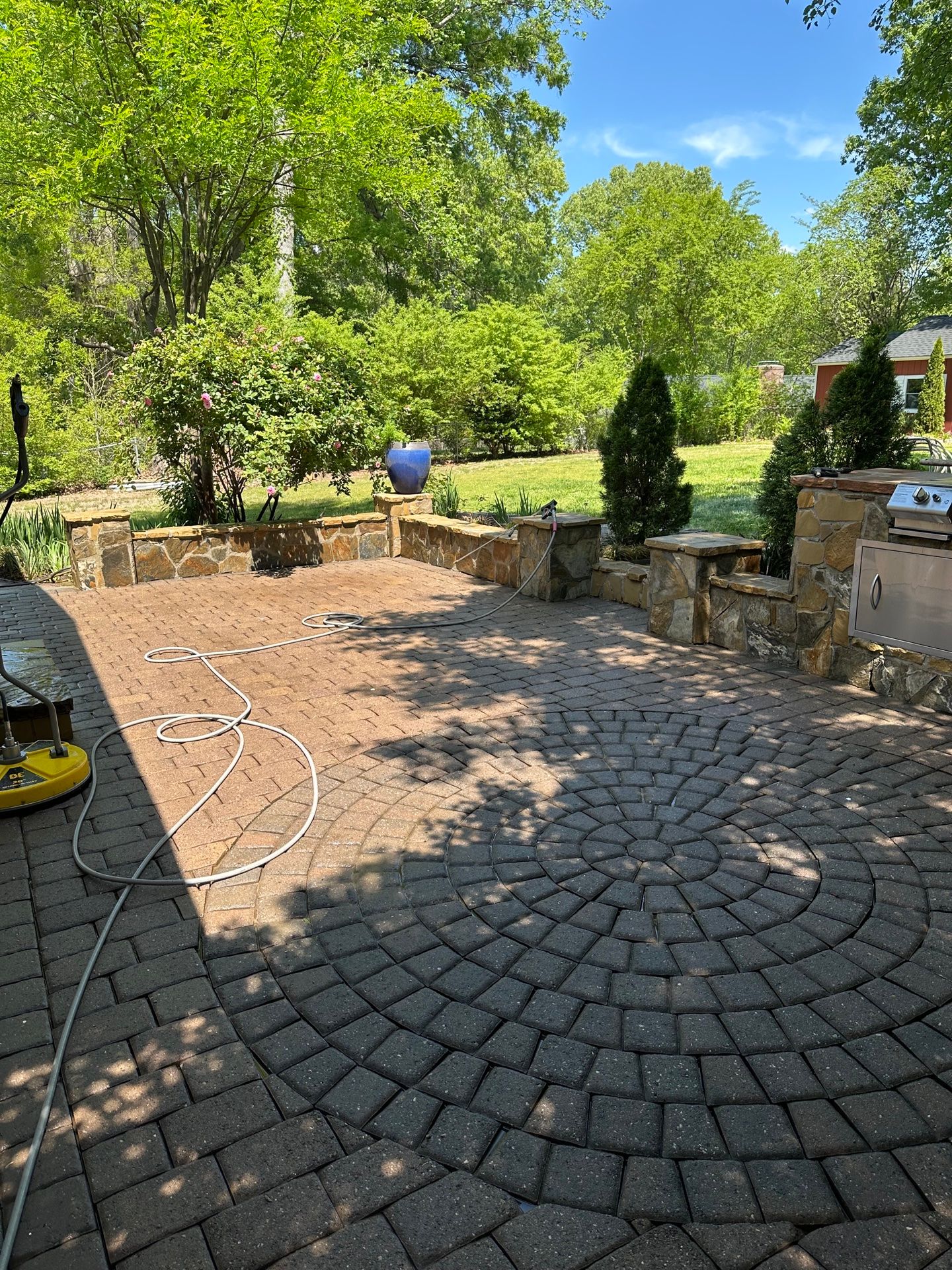 Pressure Washing in Durham, NC by Cortes Painting — pressure-washing unit and hose on a paver driveway.